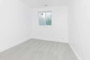 Unfurnished room featuring carpet flooring and baseboards