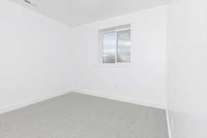 Unfurnished room with carpet floors and baseboards