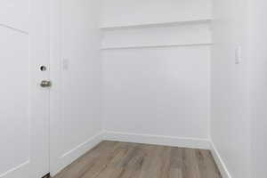Empty room with wood finished floors and baseboards