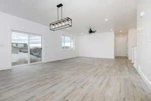 Empty room with light wood-style floors, a ceiling fan, and recessed lighting