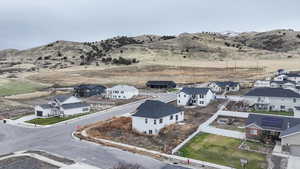 Aerial view of residential area featuring a mountainous background