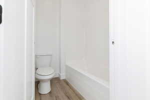 Bathroom featuring wood finished floors and shower / bath combination