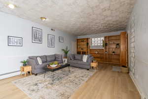 Living room featuring light wood finished floors and baseboard heating