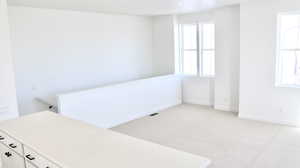 Empty room featuring light carpet and baseboards (pictures of home previously built)