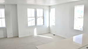 Unfurnished room featuring light colored carpet and baseboards (pictures of home previously built)