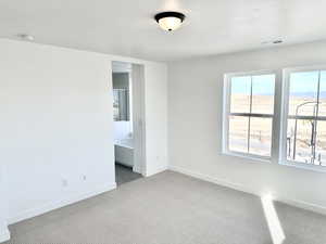 Spare room featuring light colored carpet, a textured ceiling, and a mountain view (pictures of home previously built)
