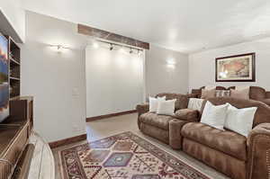 Home theater with baseboards and light colored carpet