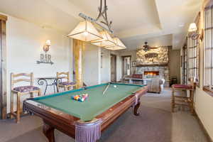 Rec room featuring a fireplace, pool table, and ceiling fan
