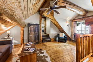 Additional living space featuring wood-type flooring, stairway, wood ceiling, and a ceiling fan