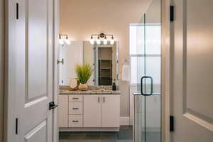 Bathroom with vanity and a stall shower
