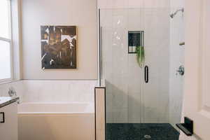 Bathroom with a bath, a shower stall, and vanity