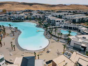 Aerial view of residential area with a pool area and a mountain backdrop