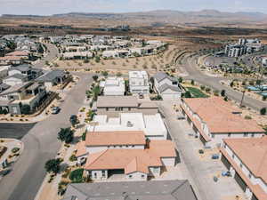 Aerial overview of property's location with a mountainous background and nearby suburban area