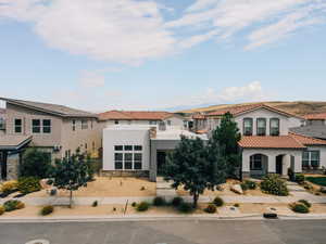 Mediterranean / spanish-style home with stucco siding and stone siding