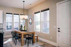Dining room with baseboards and light wood finished floors