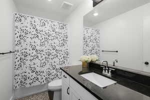 Bathroom featuring vanity and recessed lighting