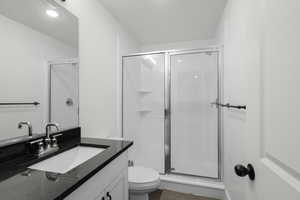 Full bath featuring vanity and a shower stall