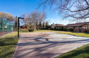 View of sport court featuring community basketball court and a residential view