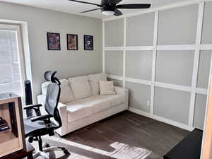Carpeted office space featuring a ceiling fan