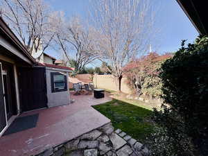 Fenced backyard with a patio
