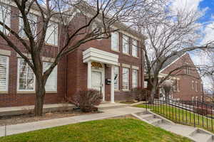 View of front of house with brick siding and a front lawn