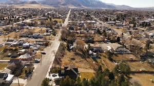 Aerial view of property's location featuring a mountain backdrop and nearby suburban area