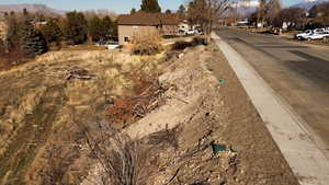 View of asphalt road with a residential view and a mountain view