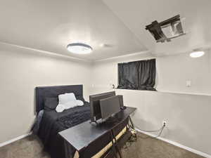 Carpeted bedroom featuring baseboards