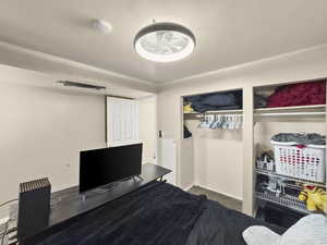 Bedroom with carpet floors and an office area