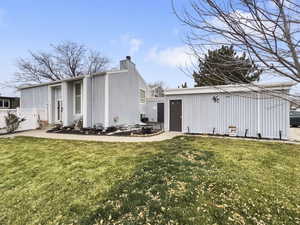 Rear view of property featuring a chimney
