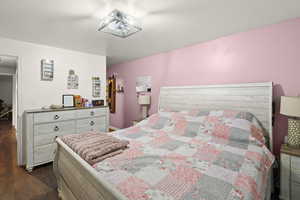 Bedroom featuring dark wood-style floors