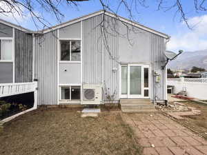 Rear view of house with entry steps and a mountain view