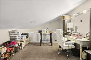 Office featuring lofted ceiling and light carpet