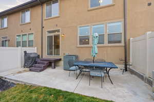 View of patio with outdoor dining area and grilling area