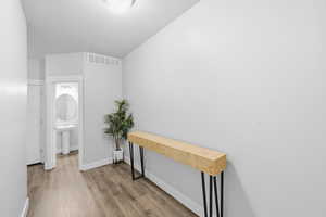 Hallway featuring baseboards and light wood-style floors