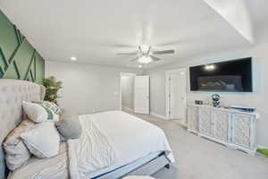 Carpeted bedroom with recessed lighting and ceiling fan