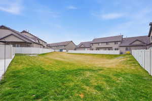 Fenced backyard featuring a residential view