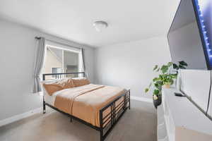 Bedroom featuring light carpet