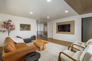 Living room with wood finished floors and recessed lighting