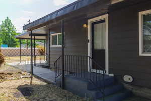 Doorway to property with covered porch