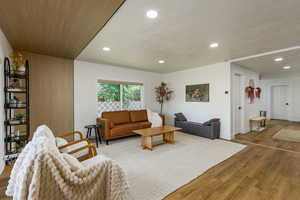 Living area with wood finished floors, recessed lighting, and a textured ceiling