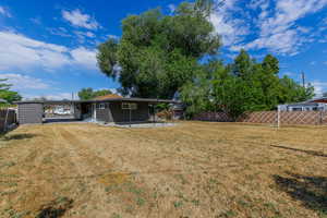 Back of property featuring a patio and a carport