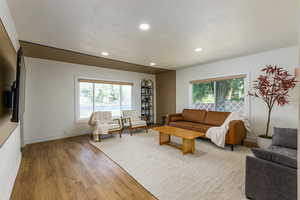 Living room featuring light wood finished floors and recessed lighting