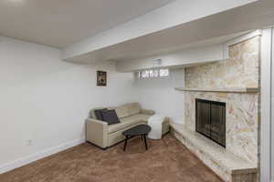 Living area featuring a fireplace and carpet