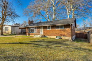 Ranch-style house featuring brick siding and a chimney