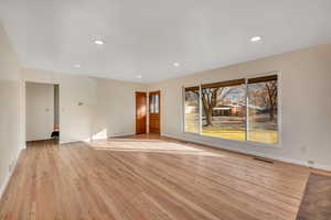 Unfurnished living room with light wood-style floors and recessed lighting
