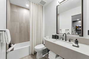 Full bathroom with shower / bath combination with curtain, vanity, and recessed lighting
