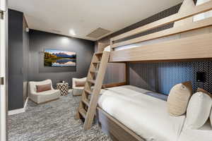 Bedroom featuring carpet flooring and baseboards