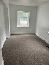 Unfurnished room with carpet and baseboards