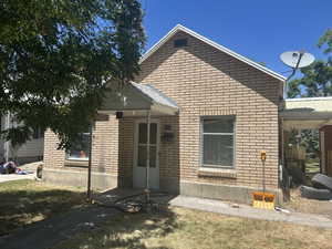 View of front of property with brick siding and a front yard